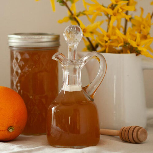 forsythia syrup in cruet with orange