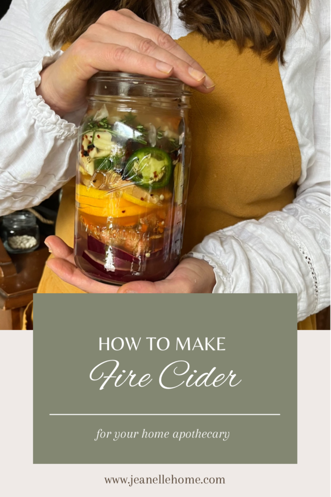 Woman holding jar of fire cider 