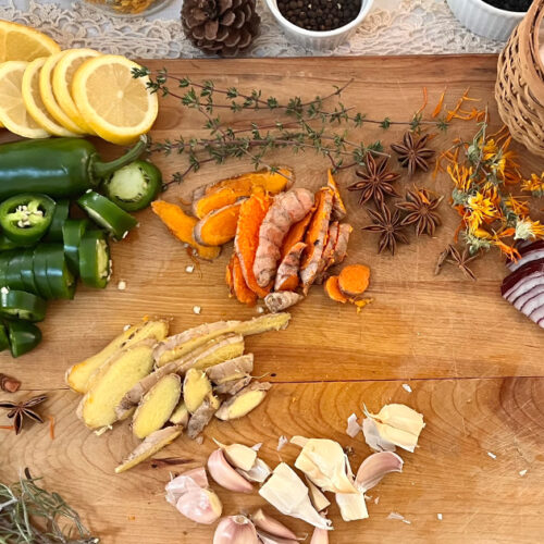 ingredients for fire cider on a wooden cutting board