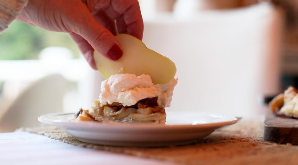 pear galette dessert on a plate with whipped cream