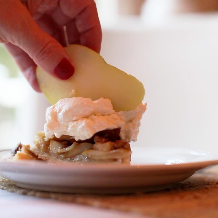 pear galette dessert on a plate with whipped cream