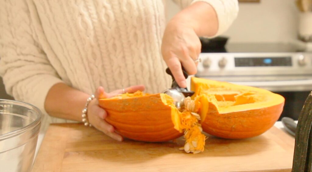 scraping seeds out of pumpkin for pumpkin puree